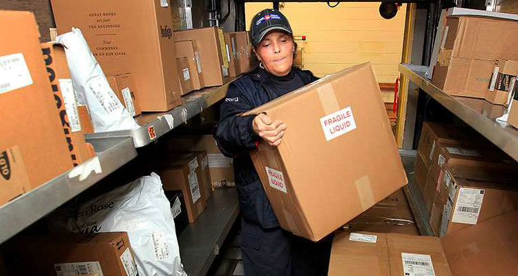 Iren Varga of Canada Post loads packages on delivery truck during pre-Christmas period Wednesday Dec. 9, 2015. NICK BRANCACCIO / WINDSOR STAR