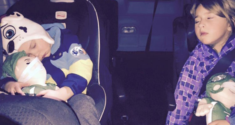 Klapak children all tuckered out after Christmas light tour and surprise gift from Regina police officers. (Photo submitted by Tyson Klapak )