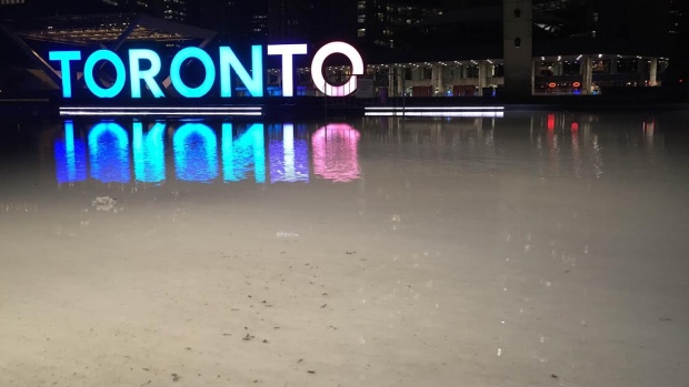 Normally frozen solid this time of year, the skating surface outside Nathan Phillips square was looking soft and watery this morning with temperatures set to hit 17 C today, smashing a record set back on Christmas Eve 1964. (Nick Boisvert/CBC)
