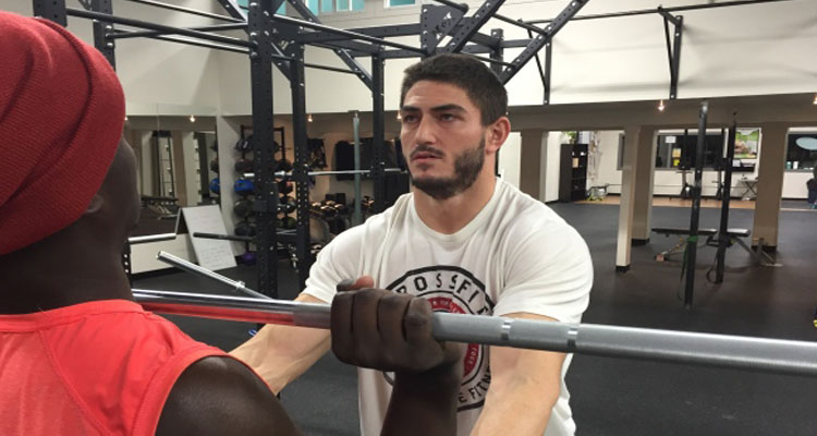 Roughrider John Chick helps train at his new CrossFit gym in Regina. (Glenn Reid/CBC)