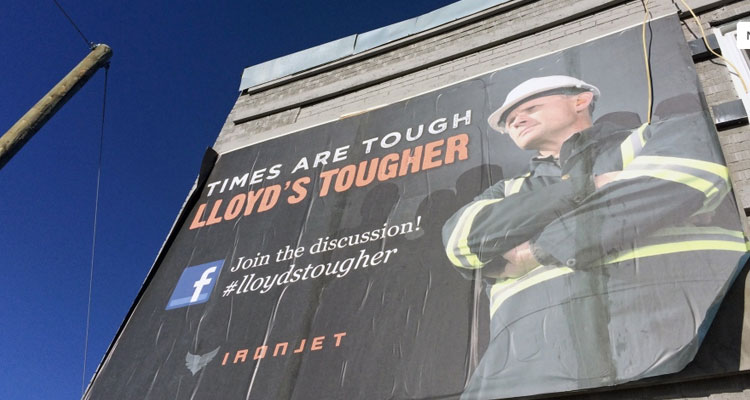 A poster hanging in Lloydminster reads "Times are tough, Lloyd's tougher." (Angelina Irinici/CTV Saskatoon)