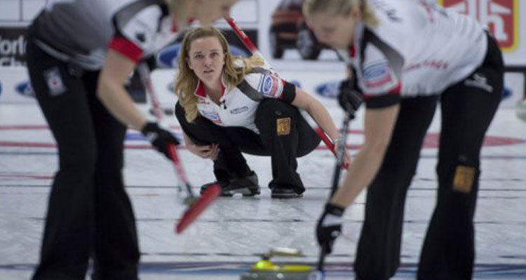 Canada's Chelsea Carey, centre, watches her shot as lead Laine Peters and second Jocelyn Peterman sweep at the world curling championships. Canada lost its first game Monday. JONATHAN HAYWARD / THE CANADIAN PRESS FILE PHOTO