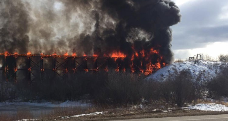 The train bridge in Porcupine Plain caught fire around 4 p.m on Good Friday. (Bryce Christianson/Facebook)