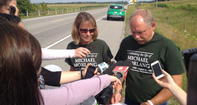 Michael Morlang's parents Brian Visneskie and Kathryn Morlang speak with reporters on Frank Kenny Rd. on Aug. 10, 2015, nearly two years after he was struck and killed on that road. (Image Courtesy of CTV News) 