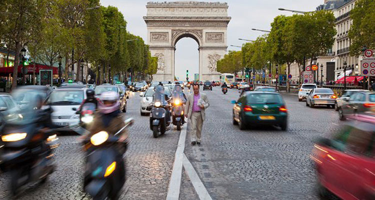 The Avenue des Champs-Elysees in front of the Arc de Triomphe in Paris. The road will be closed to vehicles one Sunday a month to combat pollution. Photograph: Holger Burmeister / Alamy/Alamy