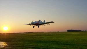 The Thrush 510P flies over a Saskatchewan field at sunset. (Devan Yaholnitsky)