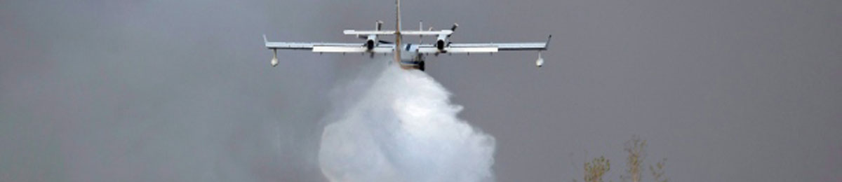 A water bomber drops water on a nearby wildfire in Fort McMurray, Alberta., on Friday, May. Russia has offered to send in extra water bombers, but Ottawa has not yet responded. (Jason Franson/Canadian Press)